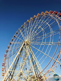 Low angle view of ferris wheel against sky