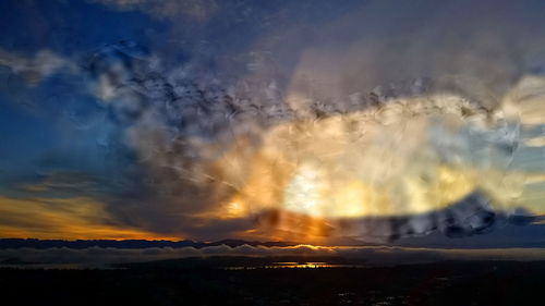 Scenic view of landscape against sky at sunset