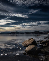 Rocks on beach against sky