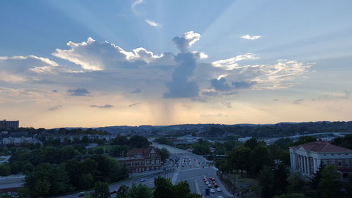 Scenic view of residential district against cloudy sky