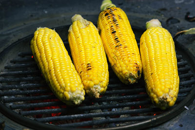 Close-up of corns on barbeque at street market