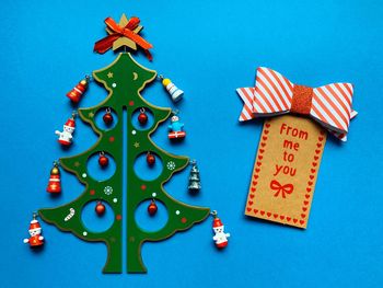 Christmas decorations on table against blue background