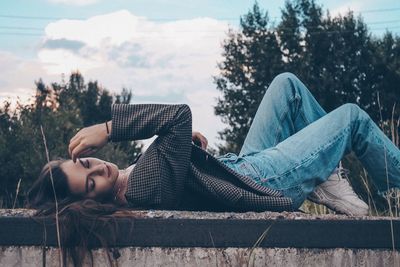 Woman relaxing by tree