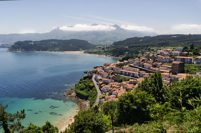 High angle view of townscape by sea against sky