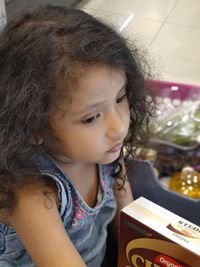 Close-up of thoughtful girl in store