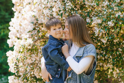 Happy family pastime of mom and son in the summer park