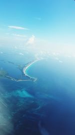 Aerial view of sea against blue sky