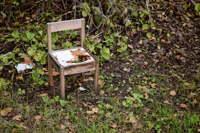 High angle view of abandoned chair on field