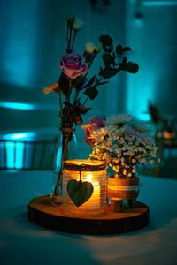 Close-up of illuminated lamp in vase on table