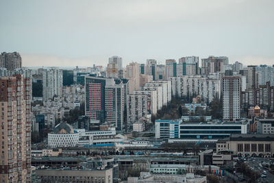 Aerial view of buildings in city against sky