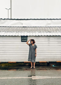 Full length of woman standing on rainy day