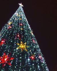 Low angle view of illuminated christmas tree at night