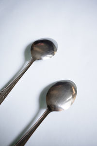 Close-up of electric lamp on table against white background
