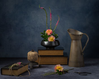 Flower pot on table against wall