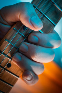 Close-up of man playing guitar