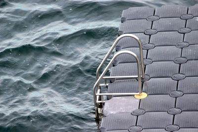 High angle view of railing by sea