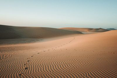 Scenic view of desert against clear sky