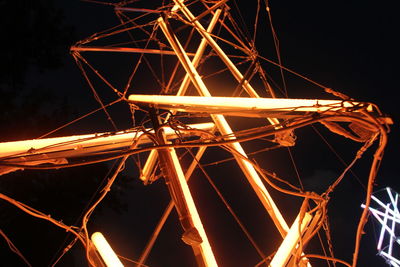 Low angle view of illuminated light against sky at night