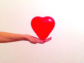 Close-up of hand holding over white background