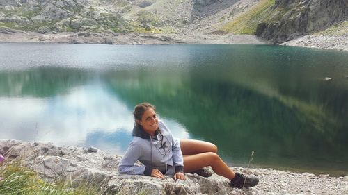 Young woman sitting on shore