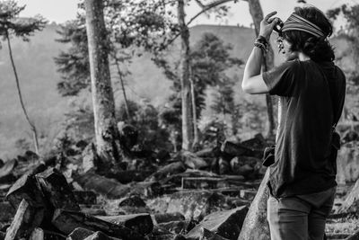 Man standing against trees