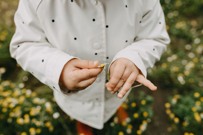 Close-up of child holding flower