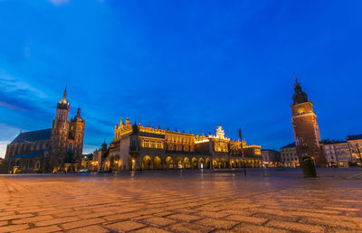 Illuminated building against blue sky at dusk in the center of krakow city, poland