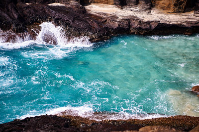 High angle view of rocks in sea