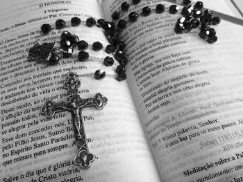 Close-up of rosary on book