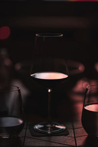 Close-up of wine glasses on table