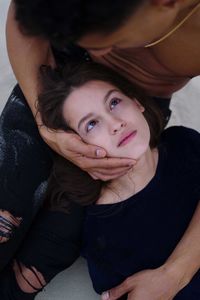 Portrait of young couple lying together on beach