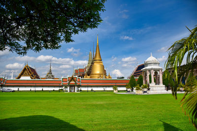 Temple by building against sky