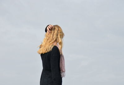 Woman standing against sky