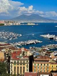 High angle view of townscape by sea against sky
