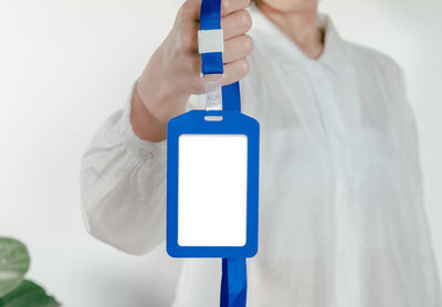 Low section of man holding mobile phone