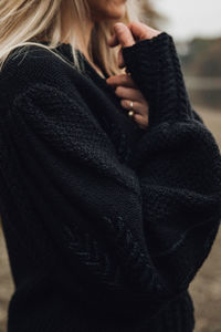 Midsection of woman wearing sweater in winter