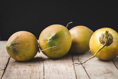 Close-up of apples on table against black background