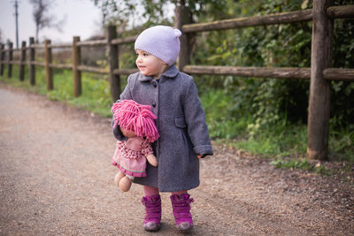 Portrait of young woman standing in park