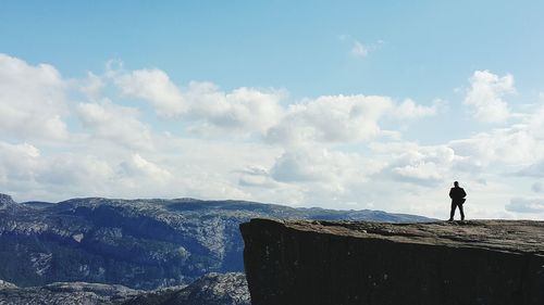 Rear view of man standing on preikestolen (pulpit rock)