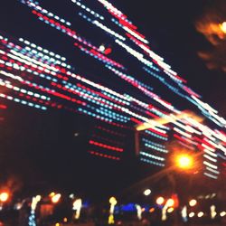 Low angle view of illuminated lights at night