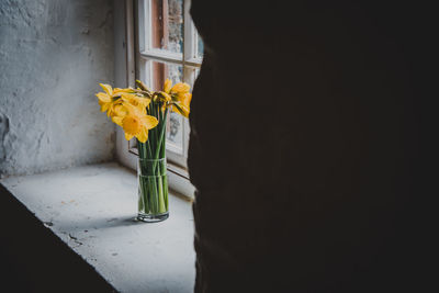 Close-up of yellow flower vase on table