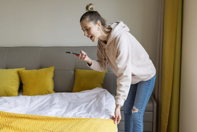 Side view of young woman using mobile phone