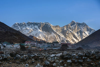 Scenic view of snowcapped mountains against clear blue sky