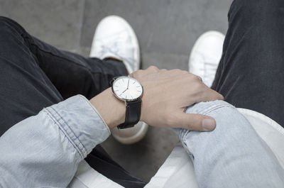 Midsection of man holding coffee cup