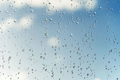 Full frame shot of raindrops on glass window