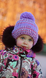 Cute girl wearing warm clothing looking away outdoors