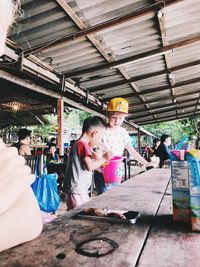 Portrait of people at market stall