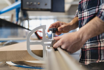 Midsection of man working at machine