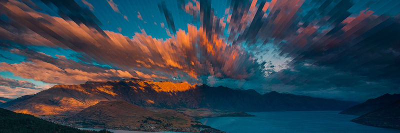 Scenic view of mountains against cloudy sky