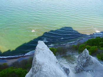 High angle view of rocks on sea shore